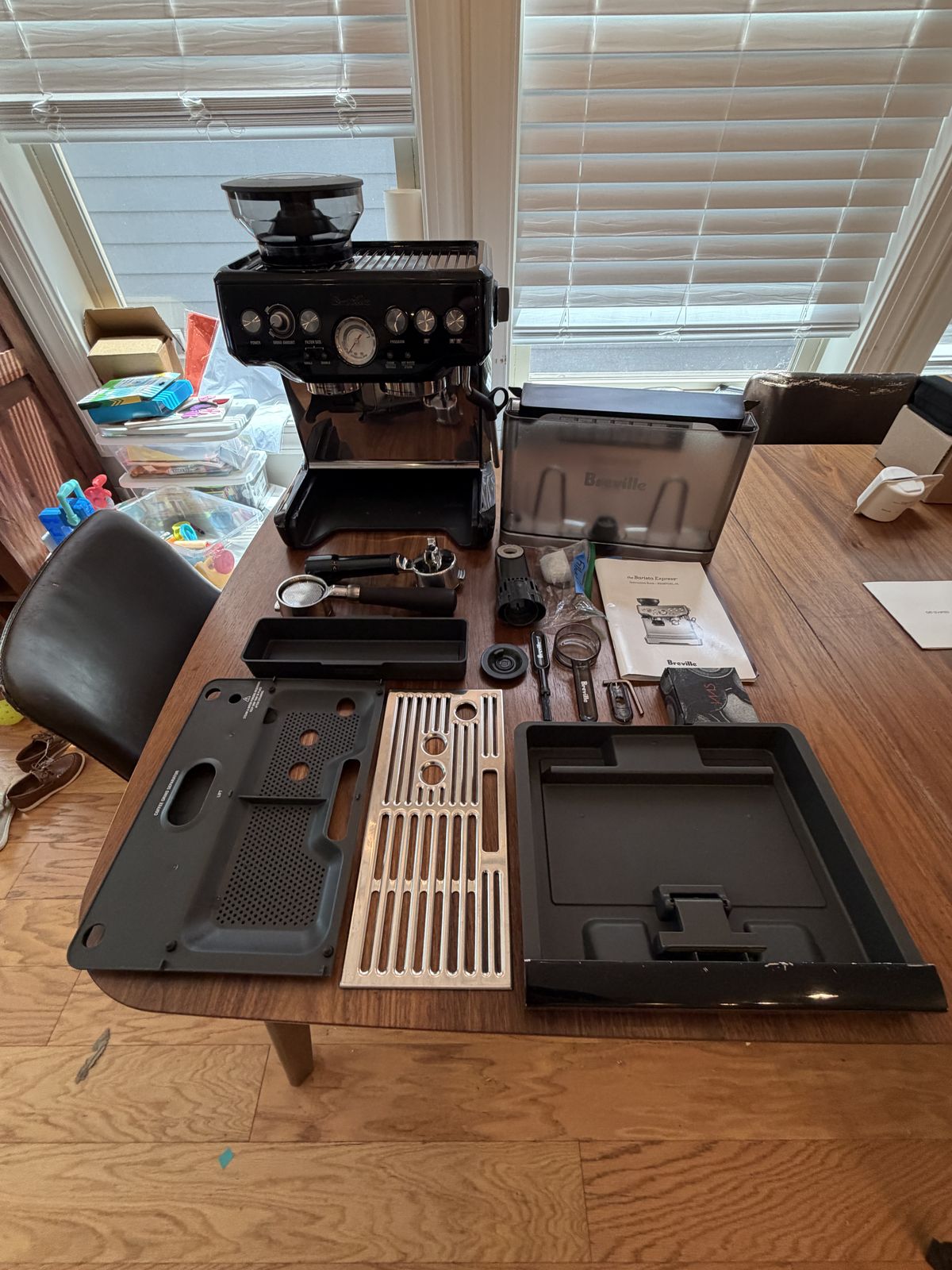 Everything included, laid out: machine, trays, portafilters, tools, and accessories