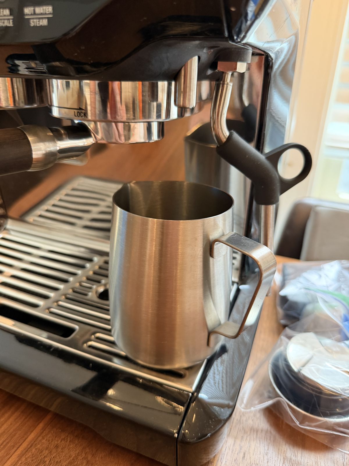 Stainless steel milk frothing jug with the machine, for lattes and cappuccinos